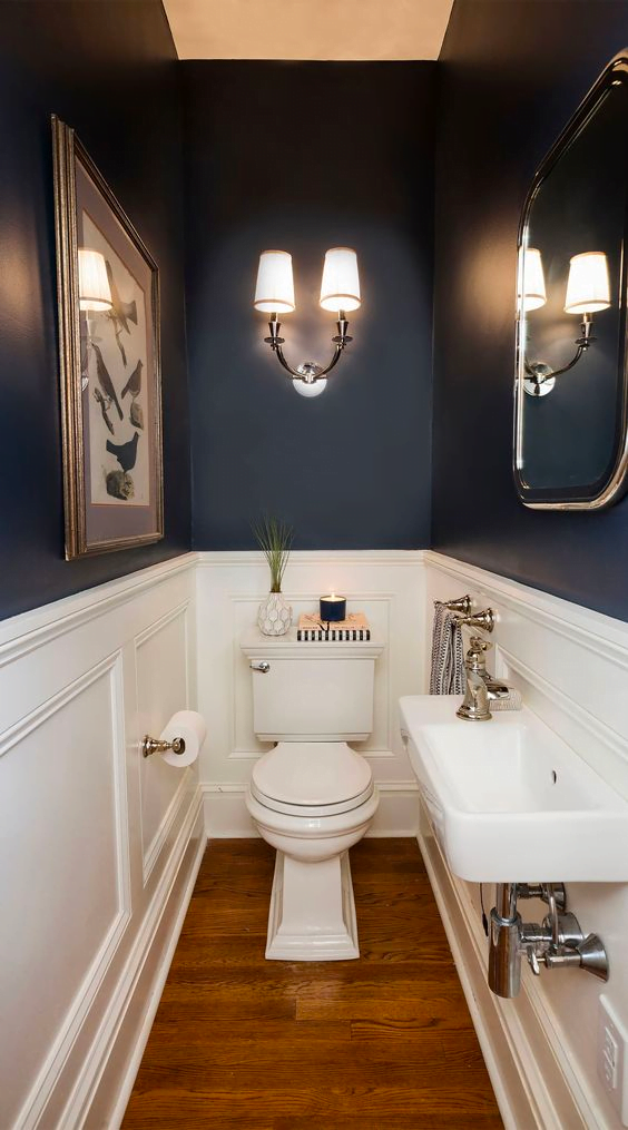 This room features a stylish design with blue and white walls. It has a classic look that is perfect for any bathroom.