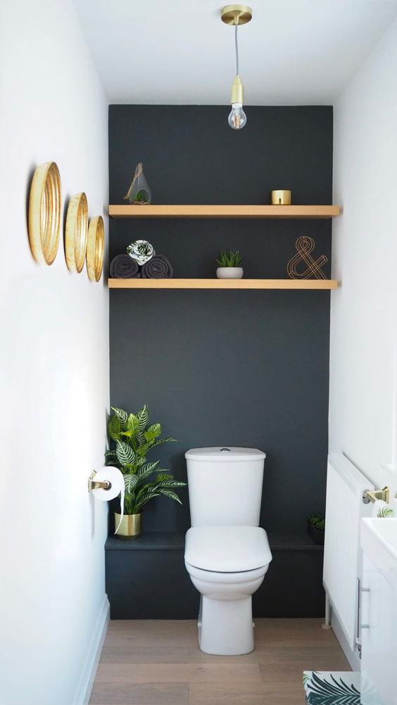 This toilet room features white and dark green walls and is decorated with various items. It offers a place to relax and refresh yourself.